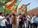Bharatiya Janata Party (BJP) supporters wave off the party's flags while celebrating the party's victory in the Lok Sabha elections (ANI) Bharatiya Janata Party (BJP) supporters wave off the party's flags while celebrating the party's victory in the Lok Sabha elections (ANI)
