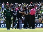 USA's players celebrate after winning the game in a super over as Pakistan's Shadab Khan walks off during the ICC men's Twenty20 World Cup 2024 group A cricket match between the USA and Pakistan at the Grand Prairie Cricket Stadium in Grand Prairie, Texas, on June 6, 2024. (Photo by ANDREW CABALLERO-REYNOLDS / AFP)