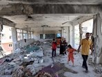 Members of a displaced family look at the damage to a school run by the UN Relief and Works Agency for Palestine Refugees (UNRWA) which was hit during an Israeli army strike the day before, in the Nuseirat camp in the central Gaza Strip on June 7, 2024, amid the ongoing conflict in the Palestinian territory between Israel and Hamas. Members of a displaced family look at the damage to a school run by the UN Relief and Works Agency for Palestine Refugees (UNRWA) which was hit during an Israeli army strike the day before, in the Nuseirat camp in the central Gaza Strip on June 7, 2024, amid the ongoing conflict in the Palestinian territory between Israel and Hamas.