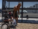 A homeless person refresh himself from water from a pipe line as temperatures are expected to soar above 110 degrees Fahrenheit (43.3 degrees Celsius) during the summer's first heat wave, in Phoenix, Arizona, U.S., June 6, 2024. REUTERS/Carlos Barria
