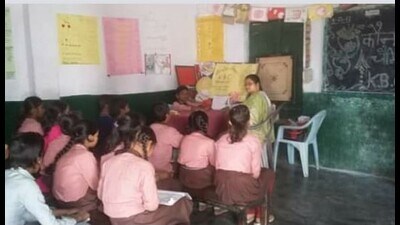 A teacher imparting lessons in a government-run primary school in Prayagraj. (HT FILE)