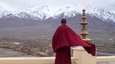 A Buddhist monk looks out to a snow-covered mountain range from Thiksay Monastery some 22 Km (13 miles) from Leh in the Indian Union territory of Ladakh on April 19, 2024. BUDDHISM (Photo by Mohd Arhaan ARCHER / AFP) (AFP) A Buddhist monk looks out to a snow-covered mountain range from Thiksay Monastery some 22 Km (13 miles) from Leh in the Indian Union territory of Ladakh on April 19, 2024. BUDDHISM (Photo by Mohd Arhaan ARCHER / AFP) (AFP)
