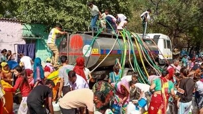 People queue up for water from tanker amid crisis in New Delhi (PTI Photo) People queue up for water from tanker amid crisis in New Delhi (PTI Photo)