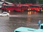 Pune: Commuters wade through a waterlogged road amid rains, in Pune, Saturday Pune: Commuters wade through a waterlogged road amid rains, in Pune, Saturday