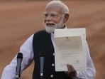 Prime-Minister-Narendra-Modi-displays-a-letter-fro Prime-Minister-Narendra-Modi-displays-a-letter-fro