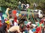People queue up for water from tanker amid crisis in New Delhi (PTI Photo)