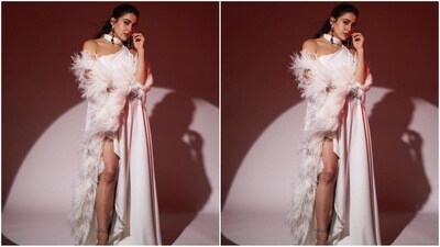 Her outfit, from the fashion brand MaisonTai, features a one-shoulder neckline with a chic cutout, a flowy silhouette, and a striking thigh-high slit for added oomph. To enhance the drama, she paired it with a white fur-embellished cape. (Instagram/@saraalikhan95) Her outfit, from the fashion brand MaisonTai, features a one-shoulder neckline with a chic cutout, a flowy silhouette, and a striking thigh-high slit for added oomph. To enhance the drama, she paired it with a white fur-embellished cape. (Instagram/@saraalikhan95)