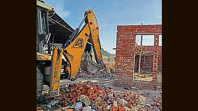 MC officials raze an illegal colony on Tajpur Road in Ludhiana on Saturday. (HT Photo)