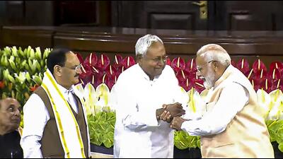 Nitish Kumar and Narendra Modi during the NDA parliamentary party meeting in Delhi on Friday. (PTI) Nitish Kumar and Narendra Modi during the NDA parliamentary party meeting in Delhi on Friday. (PTI)