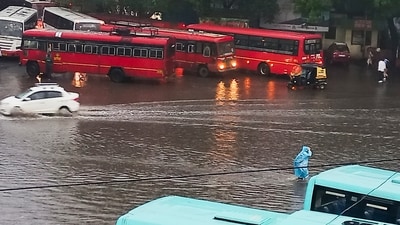 Pune: Commuters wade through a waterlogged road amid rains, in Pune, Saturday (PTI) Pune: Commuters wade through a waterlogged road amid rains, in Pune, Saturday (PTI)