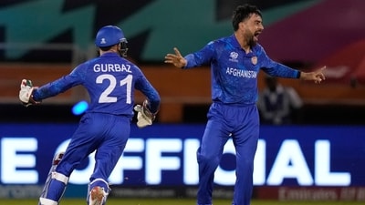 Afghanistan's captain Rashid Khan celebrates the wicket of New Zealand's Mark Chapman (AP)