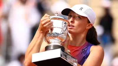 Poland's Iga Swiatek poses for a picture with the trophy after winning her final match against Italy's Jasmine Paolini (REUTERS)