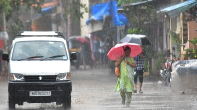 People going through the rain early in the morning at Bhandup in Mumbai. (HT photo) People going through the rain early in the morning at Bhandup in Mumbai. (HT photo)