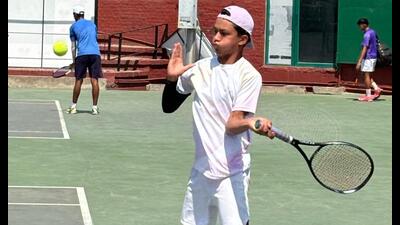 A player in action during the AITA National Series Tennis Tournament being played at the Chandigarh Lawn Tennis Association Stadium. (HT Photo)