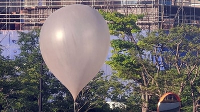 A balloon believed to have been sent by North Korea, carrying various objects including what appeared to be trash, is pictured at a park in Incheon, South Korea, (via REUTERS)