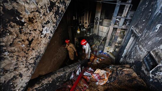 A view of fire fighters trying to douse the fire on Saturday. (Raj K Raj/HT PHOTO)