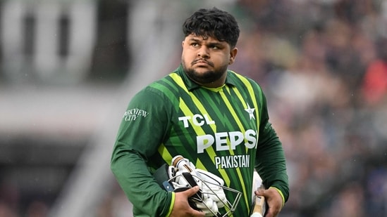 Pakistan's Azam Khan walks back to the pavilion having lost his wicket without scoring during the fourth T20 international cricket match (AFP)