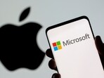 Microsoft logo is seen on the smartphone in front of displayed Apple logo in this illustration taken.