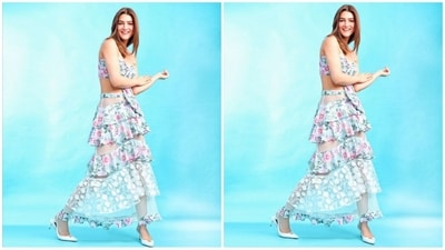 Her ensemble boasts a sky-blue hue, featuring a bralette top with delicate thin straps, a sweetheart neckline, and charming tie-on detailing in the middle. Paired with a matching maxi skirt adorned with multiple coordinating frills in sheer fabric and intricate floral white net detailing, her outfit exudes effortless elegance. (Instagram/@kritisanon) Her ensemble boasts a sky-blue hue, featuring a bralette top with delicate thin straps, a sweetheart neckline, and charming tie-on detailing in the middle. Paired with a matching maxi skirt adorned with multiple coordinating frills in sheer fabric and intricate floral white net detailing, her outfit exudes effortless elegance. (Instagram/@kritisanon)