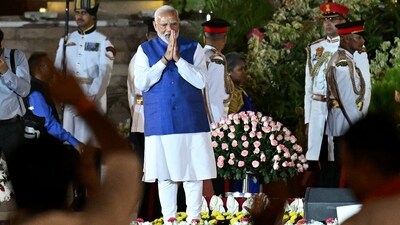 Prime Minister Narendra Modi gestures to the gathering during the oath-taking ceremony at Rashtrapati Bhavan. (AFP) Prime Minister Narendra Modi gestures to the gathering during the oath-taking ceremony at Rashtrapati Bhavan. (AFP)