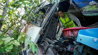 A forensic official inspects a bus that fell into a deep gorge on Sunday after being fired at by suspected militants in Reasi district, Jammu and Kashmir, (AP Photo/Channi Anand) (AP) A forensic official inspects a bus that fell into a deep gorge on Sunday after being fired at by suspected militants in Reasi district, Jammu and Kashmir, (AP Photo/Channi Anand) (AP)