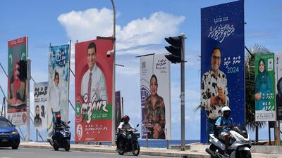 Motorists ride past hoardings of candidates for Maldives' parliamentary elections in Male in April (AFP FILE) Motorists ride past hoardings of candidates for Maldives' parliamentary elections in Male in April (AFP FILE)