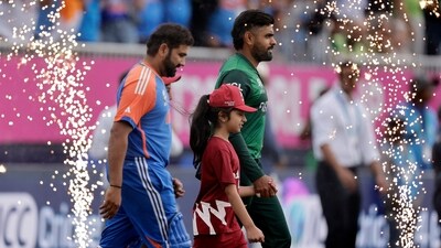 Pakistan's captain Babar Azam, right, and India's captain Rohit Sharma walk into the field before the start of the ICC Men's T20 World Cup cricket match between India and Pakistan at the Nassau County International Cricket Stadium (PTI) Pakistan's captain Babar Azam, right, and India's captain Rohit Sharma walk into the field before the start of the ICC Men's T20 World Cup cricket match between India and Pakistan at the Nassau County International Cricket Stadium (PTI)