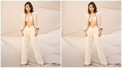 Her outfit, from the shelves of ace fashion designer Sabyasachi, features an off-white deep V-neck bralette adorned with a pink floral print. She paired it with high-waisted matching pants, accentuated by a statement Sabyasachi belt. Adding a touch of glamour, she completed the look with a matching full-sleeve jacket featuring embellished borders. (Instagram/@aliaabhatt)
