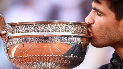 Spain's Carlos Alcaraz kisses the trophy after winning the French Open.