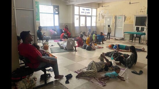 Patients and their attendants wait for their turn at the Mother and Child Hospital in Ludhiana on Monday. (HT Photo)