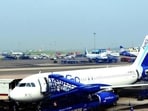 An Indigo plane alights its passengers at an airport.