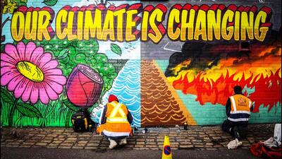 Street artists paint a mural on climate change. (AFP File Photo) Street artists paint a mural on climate change. (AFP File Photo)