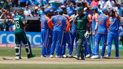 Pakistan's captain Babar Azam , center in green, walks off the field after he was dismissed by India's Jasprit Bumrah (AP)
