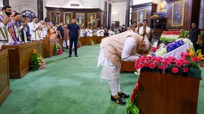 Prime Minister Narendra Modi pays respect to the Constitution of India by touching the copy with his forehead as he arrives for the National Democratic Alliance (NDA) Parliamentary Party meeting, at the Samvidhan Sadan, in New Delhi on Friday. (BJP) Prime Minister Narendra Modi pays respect to the Constitution of India by touching the copy with his forehead as he arrives for the National Democratic Alliance (NDA) Parliamentary Party meeting, at the Samvidhan Sadan, in New Delhi on Friday. (BJP)