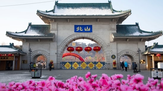 Tourists walk past a gateway with the name "Beishan" seen at the Beishan Park in northeastern China's Jilin province on Jan 23, 2020. Four instructors from Iowa's Cornell College teaching at Beihua University in northeastern China were attacked in the Beishan public park, reportedly with a knife on June 11, 2024. (Zhu Wanchang/CNS Photos via AP)