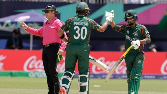 Bangladesh's Tawhid Hridoy, right, celebrates with batting partner Mahmudullah Riyad (AP)
