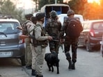 Security forces stand guard near the site of a encounter between security forces and terrorists. 