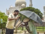 A man offers water to another on a hot summer day, near the Taj Mahal in Agra, on Wednesday. (PTI) A man offers water to another on a hot summer day, near the Taj Mahal in Agra, on Wednesday. (PTI)
