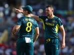 Australia's Josh Hazlewood and Mitchell Marsh talks during play