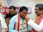 Odisha chief minister-designate Mohan Charan Majhi being congratulated by Union ministers Dharmendra Pradhan and Rajnath Singh in Bhubaneswar on Tuesday. (ANI) Odisha chief minister-designate Mohan Charan Majhi being congratulated by Union ministers Dharmendra Pradhan and Rajnath Singh in Bhubaneswar on Tuesday. (ANI)