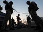 Jammu & Kashmir Police personnel stand near the site of the ongoing encounter between security forces personnel and terrorists at Saida Sukhal village in Hiranagar sector of Kathua district, on Wednesday.