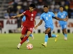Qatar's Nabil Irfan in action with India's Jay Gupta