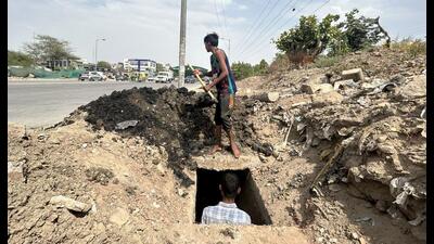 A Municipal Corporation of Gurugram (MCG) worker cleaning the drainage system to avoid water logging in monsoons at the Hero Honda Chowk, in Gurugram on Tuesday. (PARVEEN KUMAR/HT PHOTO) A Municipal Corporation of Gurugram (MCG) worker cleaning the drainage system to avoid water logging in monsoons at the Hero Honda Chowk, in Gurugram on Tuesday. (PARVEEN KUMAR/HT PHOTO)