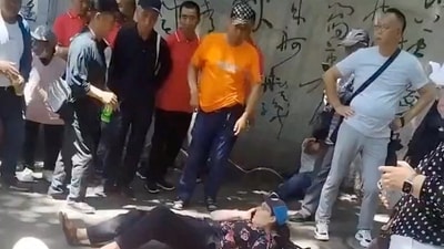 People gather around four American educators from an Iowa university, who were reportedly stabbed in a public park, according to the U.S. media and U.S. government officials, in Jilin City, Jilin province, China, in this still image taken from a video obtained by Reuters and released on June 10, 2024.  Video obtained by REUTERS  THIS IMAGE HAS BEEN SUPPLIED BY A THIRD PARTY. NO RESALES. NO ARCHIVES. (via REUTERS)