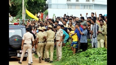 Locals gather as actor Darshan Thoogudeepa, an accused in the Renukaswamy murder case, being brought to the crime scene for investigation, in Bengaluru, on Wednesday. (PTI) Locals gather as actor Darshan Thoogudeepa, an accused in the Renukaswamy murder case, being brought to the crime scene for investigation, in Bengaluru, on Wednesday. (PTI)