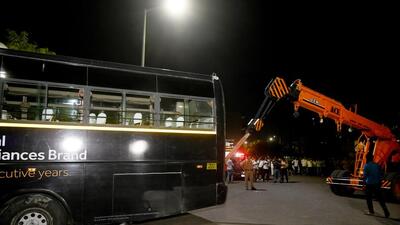 Noida police uses a crane to remove the bus that ran over a food cart and crashed into the boundary wall of a residential society in Sector 118, Noida. on Tuesday evening. Police said the bus was hired on contract by an electrical appliances manufacturing factory in Xu-2, Greater Noida, to ferry its employees. (Sunil Ghosh/HT Photo)