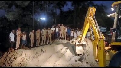 Rescue and relief work underway after a truck loaded with sand overturned on a family at a roadside shanty, in Hardoi district, Wednesday (PTI) Rescue and relief work underway after a truck loaded with sand overturned on a family at a roadside shanty, in Hardoi district, Wednesday (PTI)