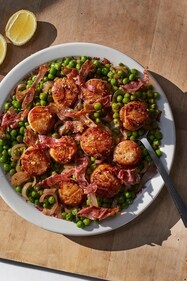 This image released by Weldon Owen shows a recipe for scallops with peas and prosciutto from the cookbook "Out There: A Camper Cookbook: Recipes from the Wild" by Lee Kalpakis. (Brittany Barb/Weldon Owen via AP) This image released by Weldon Owen shows a recipe for scallops with peas and prosciutto from the cookbook "Out There: A Camper Cookbook: Recipes from the Wild" by Lee Kalpakis. (Brittany Barb/Weldon Owen via AP)