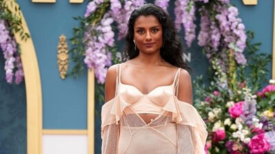 Simone Ashley poses for photographers upon arrival at the season three part two screening of the television series Bridgerton in London. Simone chose a pastel peach-coloured see-through dress by Del Core for the premiere. The ensemble features a plunging neck bralette, off-shoulder sleeves, a breezy silhouette, and an asymmetric hem.&nbsp; (Scott A Garfitt/Invision/AP)