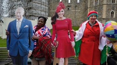 Royal supporters hold cardboard cutout of Britain's King Charles III and Princess of Wales Kate, outside the Windsor Castle where Royal family attending the Easter Matins Service in Windsor, England, Sunday, March 31, 2024. (AP Photo/Kin Cheung) (AP) Royal supporters hold cardboard cutout of Britain's King Charles III and Princess of Wales Kate, outside the Windsor Castle where Royal family attending the Easter Matins Service in Windsor, England, Sunday, March 31, 2024. (AP Photo/Kin Cheung) (AP)
